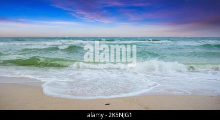velvet season seascape. waves rushing on the beach. cloudy sky before the evening storm Stock Photo