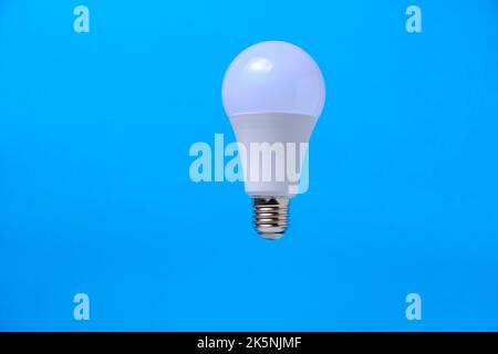LED eco light bulb on blue background Stock Photo