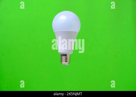 LED eco light bulb on green background Stock Photo