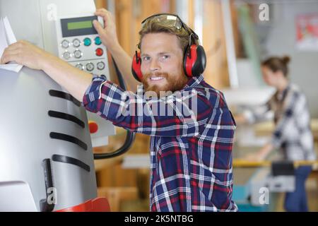 industrial worker operates a machine Stock Photo