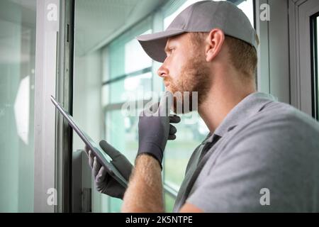construction worker looking thoughtful while using digital tablet Stock Photo