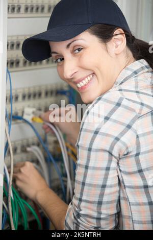 technician connecting wires on server in data center Stock Photo