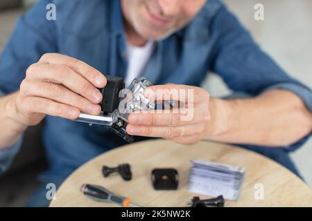 man assembling and testing his new action prtable camera Stock Photo