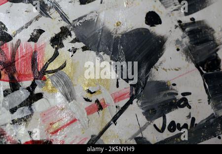 Interesting colors and textures embracing creativity and all the colors of life! A closeup of a paper covered with different paints in a process. Stock Photo