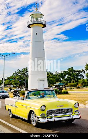 A 1955 Chevrolet Bel Air convertible passes the Biloxi lighthouse during the 26th annual Cruisin’ the Coast antique car show in Biloxi, Mississippi. Stock Photo