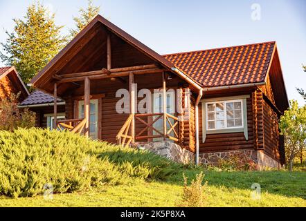 Wooden house in the village on the background of nature. Stock Photo