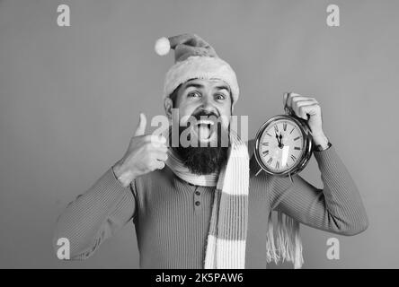 Santa Claus waits for New Year on red background. Stock Photo