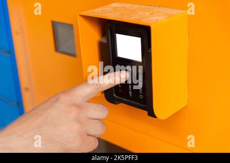 Finger dials pin code on terminal. Transaction pay and shopping concept. Close Up of Male Hand entering Personal Identification Number at an ATM Machi Stock Photo