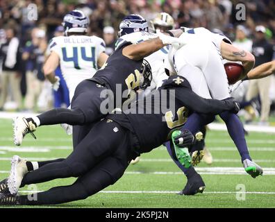 New Orleans, USA. 09th Oct, 2022. New Orleans Saints running back Dwayne Washington (24) and defensive end Tanoh Kpassagnon (90) both tackle Seattle Seahawks punter Michael Dickson (4) during a National Football League Contest at the Caesars Superdome in New Orleans, Louisiana on Sunday, October 9, 2022. (Photo by Peter G. Forest/Sipa USA) Credit: Sipa USA/Alamy Live News Stock Photo