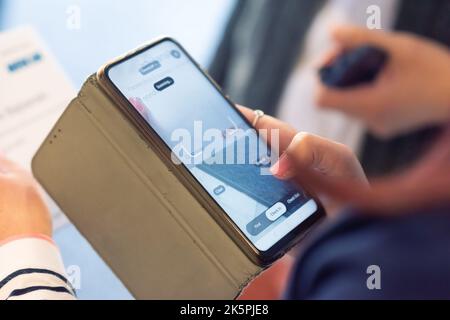 Conference Staff Member scan a QR code from attendee upon arrival to check-in site Stock Photo