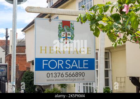 Estate agent's 'For Sale' sign outside period property, West Street, Coggeshall, Essex, England, United Kingdom Stock Photo