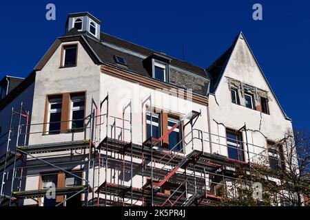 scaffolded old damaged building with cracks in the facade Stock Photo