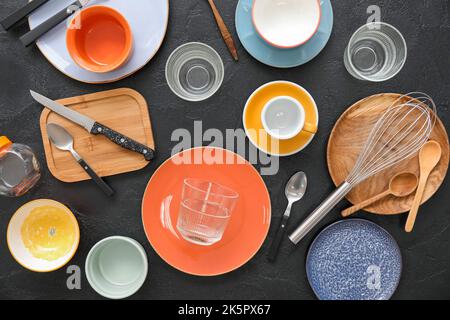 Many different tableware and kitchenware on dark background, top view Stock Photo