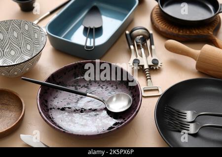 Many different tableware and kitchenware on color background Stock Photo