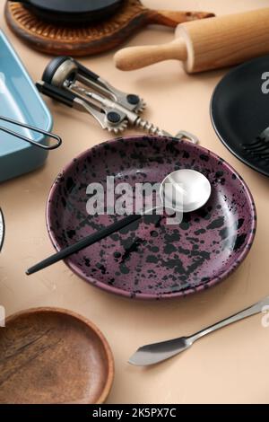 Many different tableware and kitchenware on color background Stock Photo