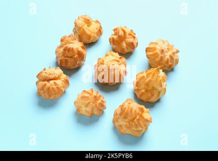 Composition with delicious eclairs on color background Stock Photo