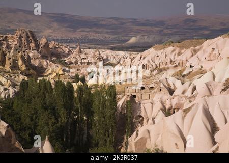 Uchisar village with rock-cut cave dwellings in the Pigeon valley near Goreme, Cappadocia region, Turkey. Stock Photo