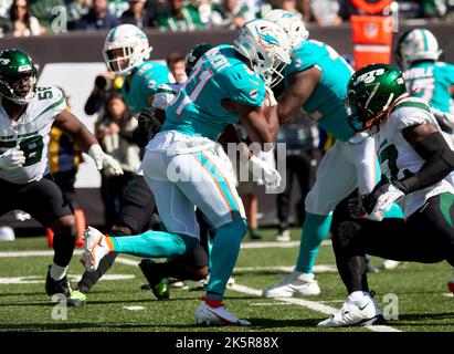 Miami Dolphins running back Raheem Mostert, left, gives autographs to fans  after practice on Back Together Weekend at the NFL football team's  training facility, Sunday, July 30, 2023, in Miami Gardens, Fla. (