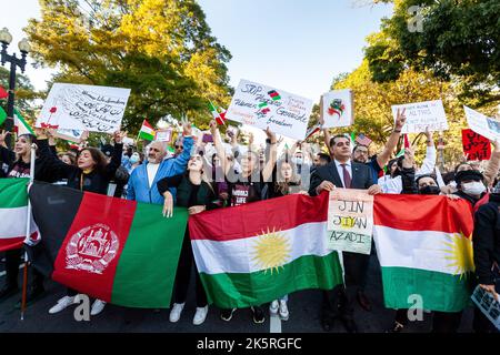 Washington, United States. 08th Oct, 2022. Protesters carry Kurdish, Aghan, and pre-1979 Iranian flags at the front of a march for Mahsa Amini, the young woman who died last month in custody of Iran's morality police. Demonstrations have taken place daily in Iran since the 22-year-old's death became public in mid-September. Credit: SOPA Images Limited/Alamy Live News Stock Photo