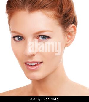 Stunning beauty with clean skin and soft smile. Isolated closeup of a beautiful woman with amazing skin smiling gently at the camera- copyspace. Stock Photo