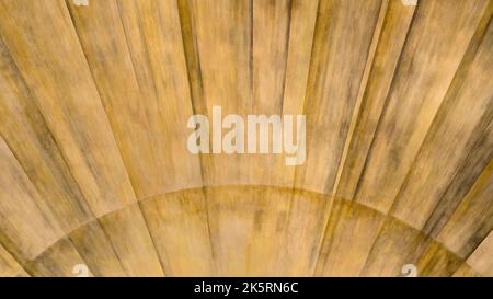 Ocher brown painted pattern with rays in a semicircle on a wall Stock Photo