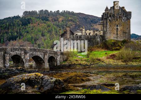 The old stone arch bridge leading to Eilean Donan Castle in Dornie Village, Scotland, United Kingdom Stock Photo