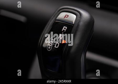 Close-up on automatic transmission lever in modern car. Car interior details. Transmission shift. Parked gear. Selective focus gear knob Stock Photo