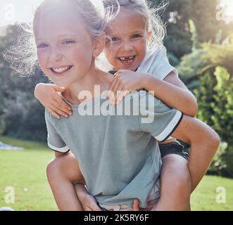 Children, smile and sister piggy back girl outdoor being playful, happy or relax together for summer holiday. Siblings, sisters and playing excited on Stock Photo