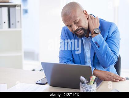 Burnout, stress or man with neck pain working on laptop with headache, depression or mental health in office. Frustrated, sad or tech employee or Stock Photo