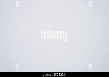 winter background texture fresh snow covering ground. natural abstract pattern flat rough coating snow surface. white icy frozen snowflakes on light c Stock Photo