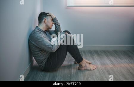 Man with problems resting sitting on the floor Stock Photo