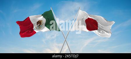 two crossed flags japan and mexico waving in wind at cloudy sky. Concept of relationship, dialog, travelling between two countries. 3d illustration Stock Photo