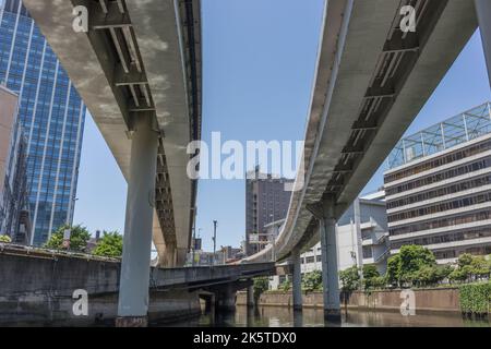 Elevated expressway roads and buildings,, viewed from below, from the Sumida river, Tokyo, Japan. Stock Photo