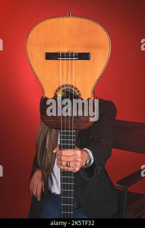 Beautiful young woman playing a CUATRO, typical Venezuelan instrument. Recording session, Concept of music and typical instruments. Stock Photo