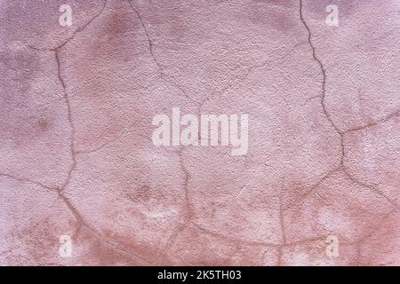 Abstract background of pink textured plaster with cracks Stock Photo