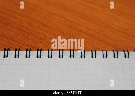 Notepad on a wooden table with copy space. View from above. Design blank. Stock Photo