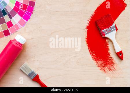 Paintbrush and color palette guide, top view. House renovation tools Stock Photo