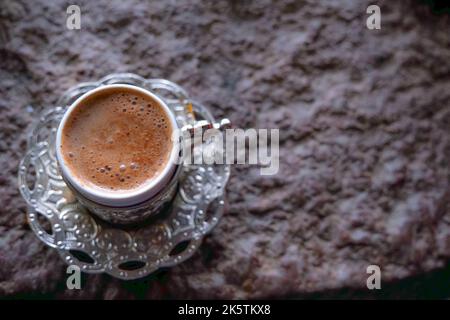 Copper cups with Turkish coffee cooked in hot sand. Stock Photo
