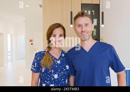 Portrait of dentist posing with nurse in dentists ambulance. Stock Photo