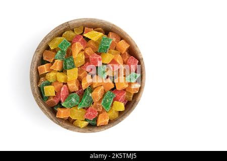 diced candied fruits in wooden bowl isolated on white, peel of oranges, papayas and succade used as filling in confectionery, baking or as additive in Stock Photo