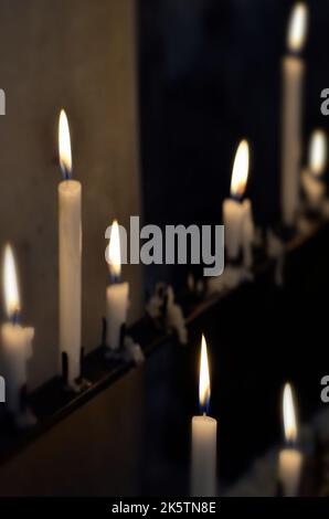 lit burning candles in church Stock Photo