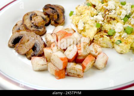 https://l450v.alamy.com/450v/2k5tpym/scallion-and-blue-cheese-scrambled-eggs-with-side-dishes-of-sauteed-mushrooms-and-crab-meat-sticks-2k5tpym.jpg