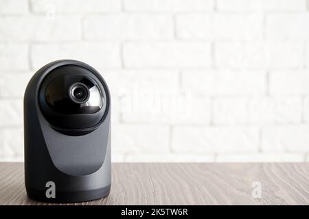 Security IP camera on the table in the apartment. Home access and control. CCTV Stock Photo