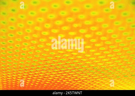 Abstract toxic neon orange perforated surface background. Technology and audio concepts and symbols Stock Photo