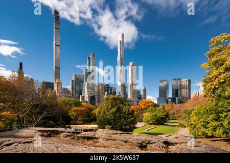 Central Park in Fall with view of the skyscrapers of Billionaires' Row in morning light. Midtown Manhattan, New York City Stock Photo