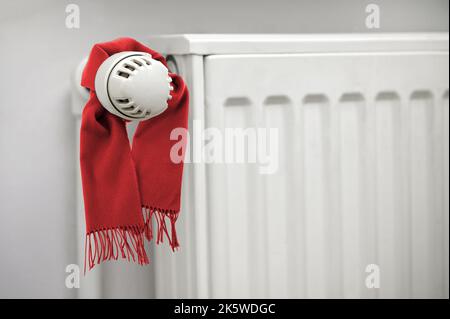 Conceptual Winter Classic Scarf On A Thermostat. Energy Saving On A House Stock Photo