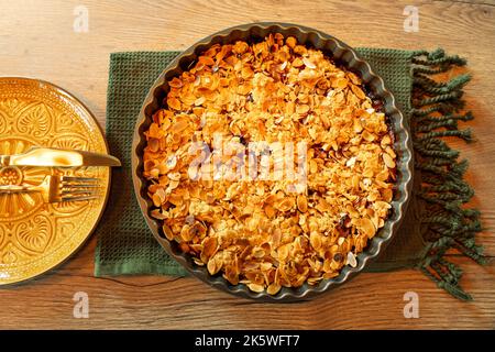 autumn stlye crumble cake flat lay with almond slices Stock Photo