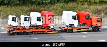 Six factory-new variants DAF lorry truck cab body specialised commercial vehicle transport & adjustable low loader trailer driving on UK motorway road Stock Photo