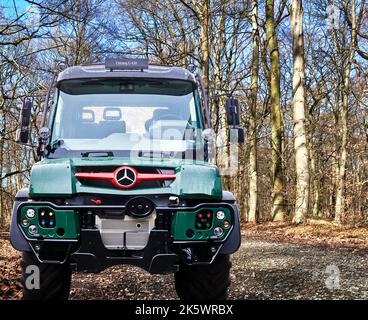 Unimog U430 legendary small truck for difficult terrain from Mercedes Benz, composite in a forest road, Hannover, Germany, September 24, 2022 Stock Photo