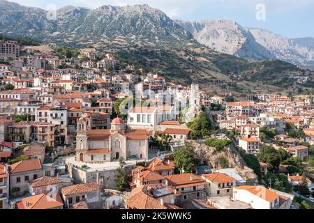 Greece, Arachova village in Boeotia aerial drone view. Traditional mountain town. Tiled roof houses and stone tower clock, tourist resort Stock Photo